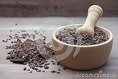 Cacao nibs raw crushed beans in pestle Stock Photo