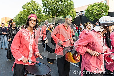 Painted and disguised musicians during the celebration of the feast of Saint George and the dragon. Editorial Stock Photo