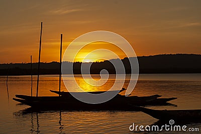 Silhouette at sunset of canoes docked in the grandiose Paraguacu river Stock Photo