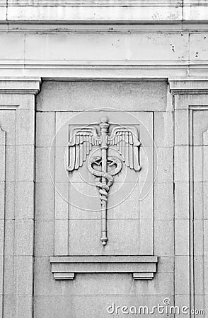 Caduceus bas-relief on vintage building exterior Stock Photo