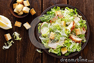 Caesar salad with grilled chicken meat, fresh lettuce, parmesan cheese and fried croutons. Classic North American cuisine Stock Photo