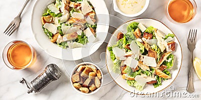 Caesar salad panorama with the classic sauce and wine, shot from above Stock Photo