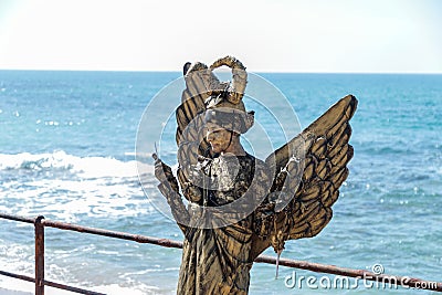 A participant of the Purim festival stands dressed in a fairy statue costume in Caesarea, Israel Editorial Stock Photo