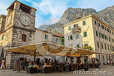 A cafe at the Clock Tower at the Square of Arms, the Old Town of Kotor Editorial Stock Photo