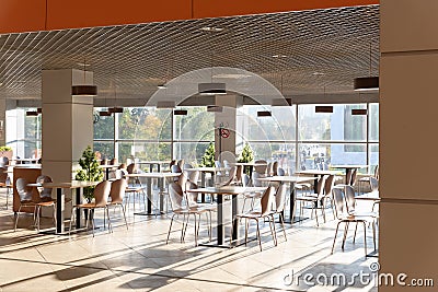 Cafe Interior. Modern cafe interior with bright room with tables and chairs nobody, large windows, modern style Stock Photo