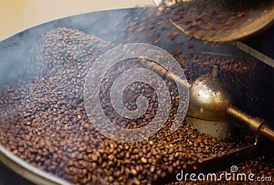 Cafe, mix and coffee beans in a machine for a raw blend, textures and steam in a pot. Food, industry and espresso and Stock Photo