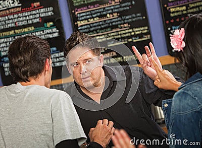 Cafe Owner with Rude Customer Stock Photo