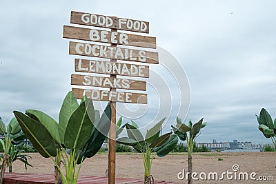 Cafe signpost on the beach Stock Photo