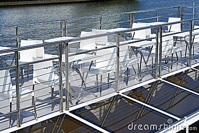 Cafe tables on deck of pleasure boat Stock Photo