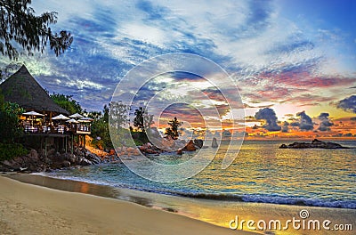 Cafe on tropical beach at sunset Stock Photo