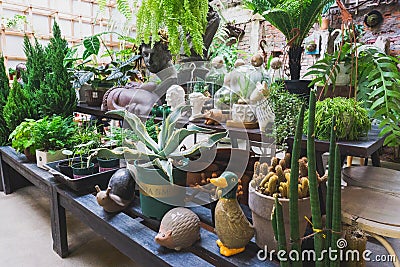 Cafeteria Interior with modern design and furniture decorated with plenty of green plants and wood materials in Vietnam, November Editorial Stock Photo