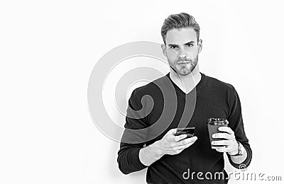 Caffeine and smartphone addiction. Handsome man use phone drinking coffee. Addiction to technology Stock Photo