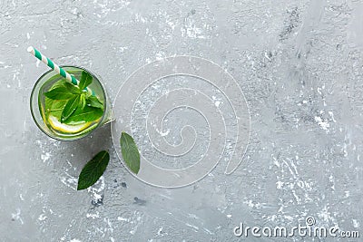 Caipirinha, Mojito cocktail, vodka or soda drink with lime, mint and straw on table background. Refreshing beverage with Stock Photo