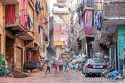 18/11/2018 Cairo, Egypt, inhabitants of garbage city in the streets of his area among a bunch of garbage Editorial Stock Photo