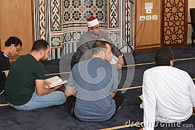 A Noble Quran reading ring inside a mosque at the day of Arafah or Arafat before Eid Al-Adha Editorial Stock Photo