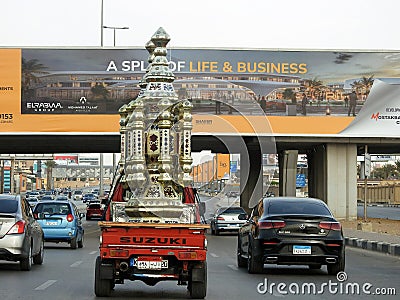 Cairo, Egypt, March 23 2023: A car transporting large Fanous lantern Islamic lamp of Ramadan to deliver it, Fanos Ramadan is a Editorial Stock Photo