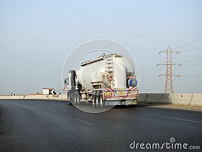 Cairo, Egypt, May 20 2023: A big truck with a container tank with petroleum products, a lorry on the highway with a container on Editorial Stock Photo