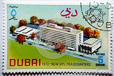 An old postage stamp printed in United Arab Emirates UAE Dubai shows Inauguration of the new headquarters of the UPU Editorial Stock Photo