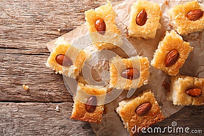 Cake with almonds basbousa on paper. Horizontal top view Stock Photo