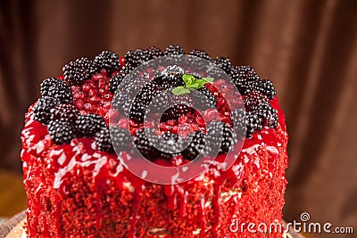 Cake baked from a sponge cake, decorated with ripe juicy blackberries, black raspberries, close Stock Photo
