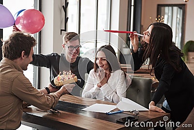 Cake and balloons. One of employees have birthday today. Friendly coworkers decides to make surprise for her Stock Photo