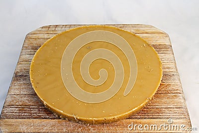 Cake of beeswax isolated on a wooden board Stock Photo