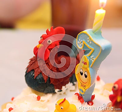 Cake candle birthday party rooster seven years old Stock Photo