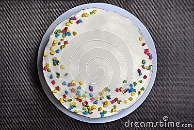 Cake candy sprinkles on a gray background. The view from the top of the cake standing on the table. Pastries are handmade on a Stock Photo