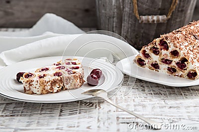 cake with cherries, cream and chocolate on a light wooden background Stock Photo