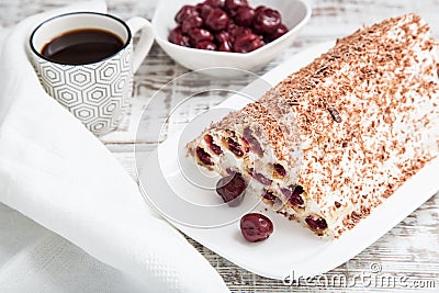 cake with cherries, cream and chocolate on a light wooden background Stock Photo