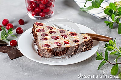 Cake with cherries, cream and chocolate on a plate on a light background. Stock Photo