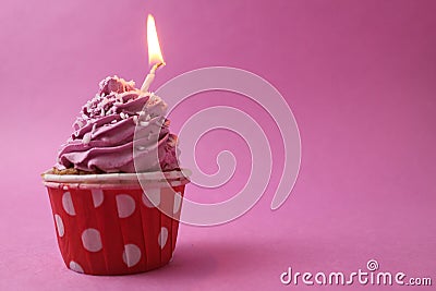 cake cupcake basket with a cap of cream pink lilac with a burned candle. Anniversary 1 year holiday birthday with space Stock Photo