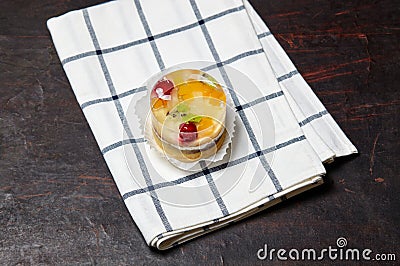 Cake with jelly, kiwi, cherries and mango on table Stock Photo