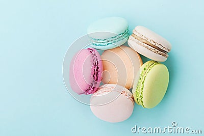 Cake macaron or macaroon on turquoise background from above, almond cookies, pastel colors Stock Photo