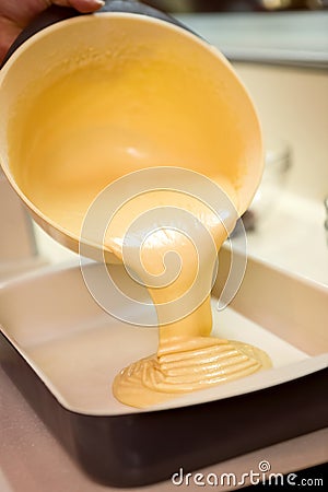 Cake mixture being poured Stock Photo