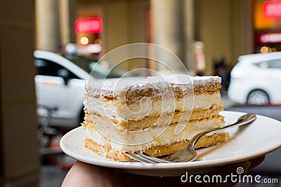 Cake on a plate on the street background Stock Photo