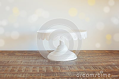 Cake plate on vintage wooden table over bokeh background Stock Photo