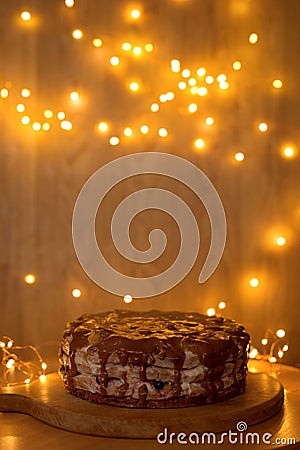 Cake on the background of blurry lights. Stock Photo