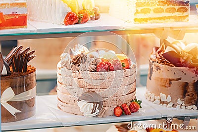 cake with strawberries, yummy assortment baked pastry in bakery. Various Different Types Of Sweet Cakes In Pastry Shop Stock Photo