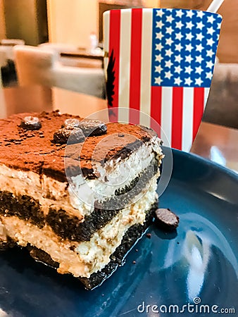 Cup of coffee with USA flag print and tasty cream cake Tiramisu Stock Photo