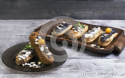 Cakes eclairs, mint, berries Physalis Stock Photo