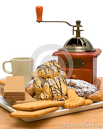 Cakes, pastries, coffee cup and coffee grinder Stock Photo