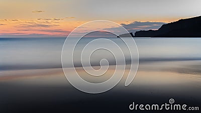 Cala Mesquida, sunrise, beach, mediterranean sea, hills, rocks, golden sun reflection on water, Blue sky with clouds, Mallorca, Stock Photo