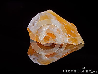 Calcite orange close-up. Black background. Macro image. Stock Photo