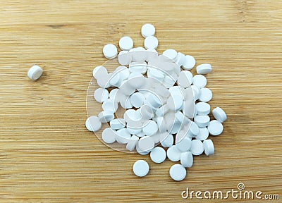 calcium pills on wooden background Stock Photo