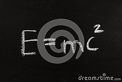 The calculation for mass energy equivalence ist standing on a chalkboard, physic formular Stock Photo