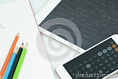 Calculator on book with color pencil and tablet on wood table. Concept Learn new styles. Stock Photo