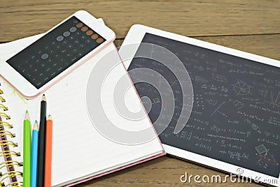 Calculator on book with color pencil and tablet on wood table. Concept Learn new styles. Stock Photo