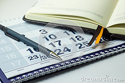 Calculator and business notebook on the calendar background Stock Photo