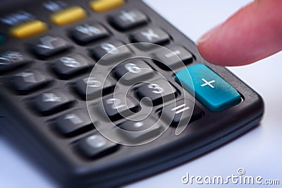 Calculator with button plus. Stock Photo